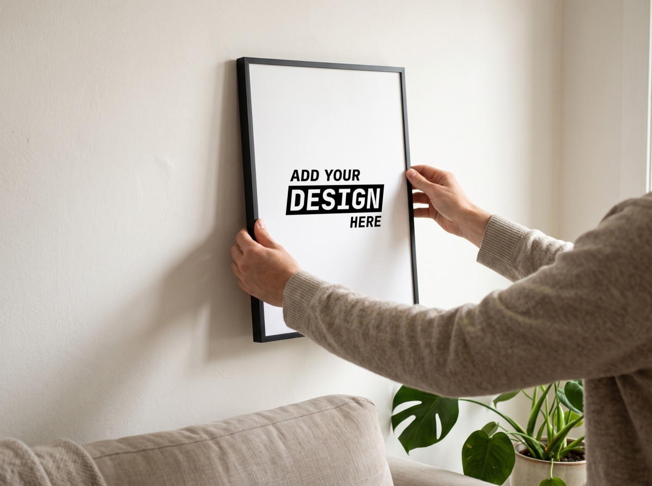 Black Frame Mockup Being Hung on a White Living Room Wall