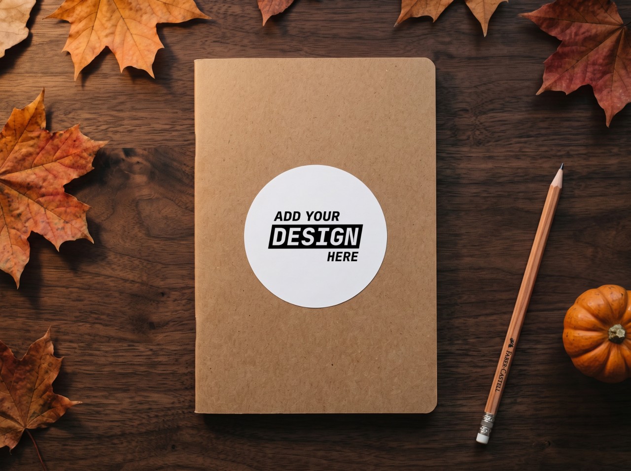 Round Sticker Halloween Mockup on a Kraft Notebook with Autumn Leaves