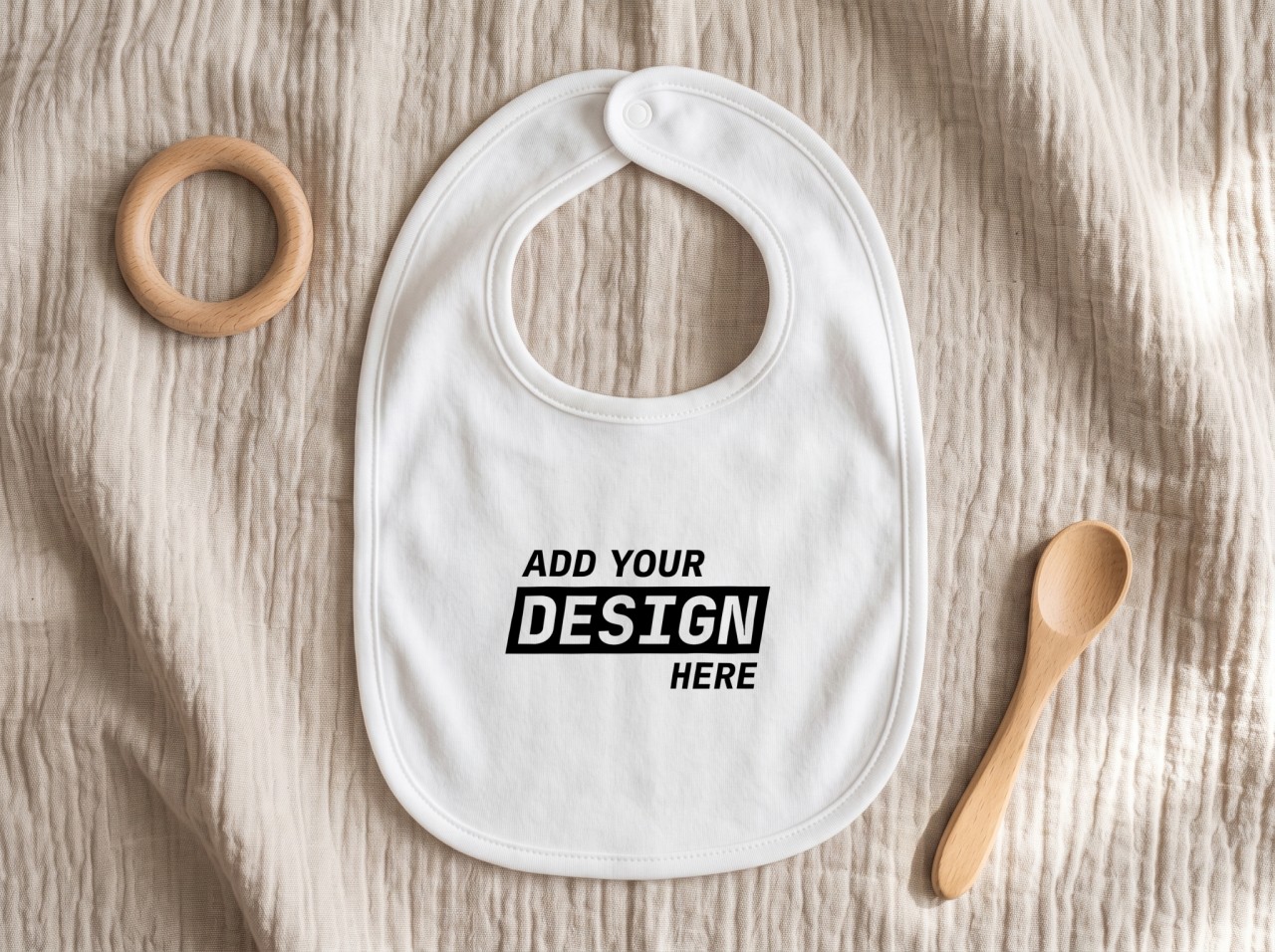 White Baby Bib Mockup Flat Lay on Muslin with a Teether