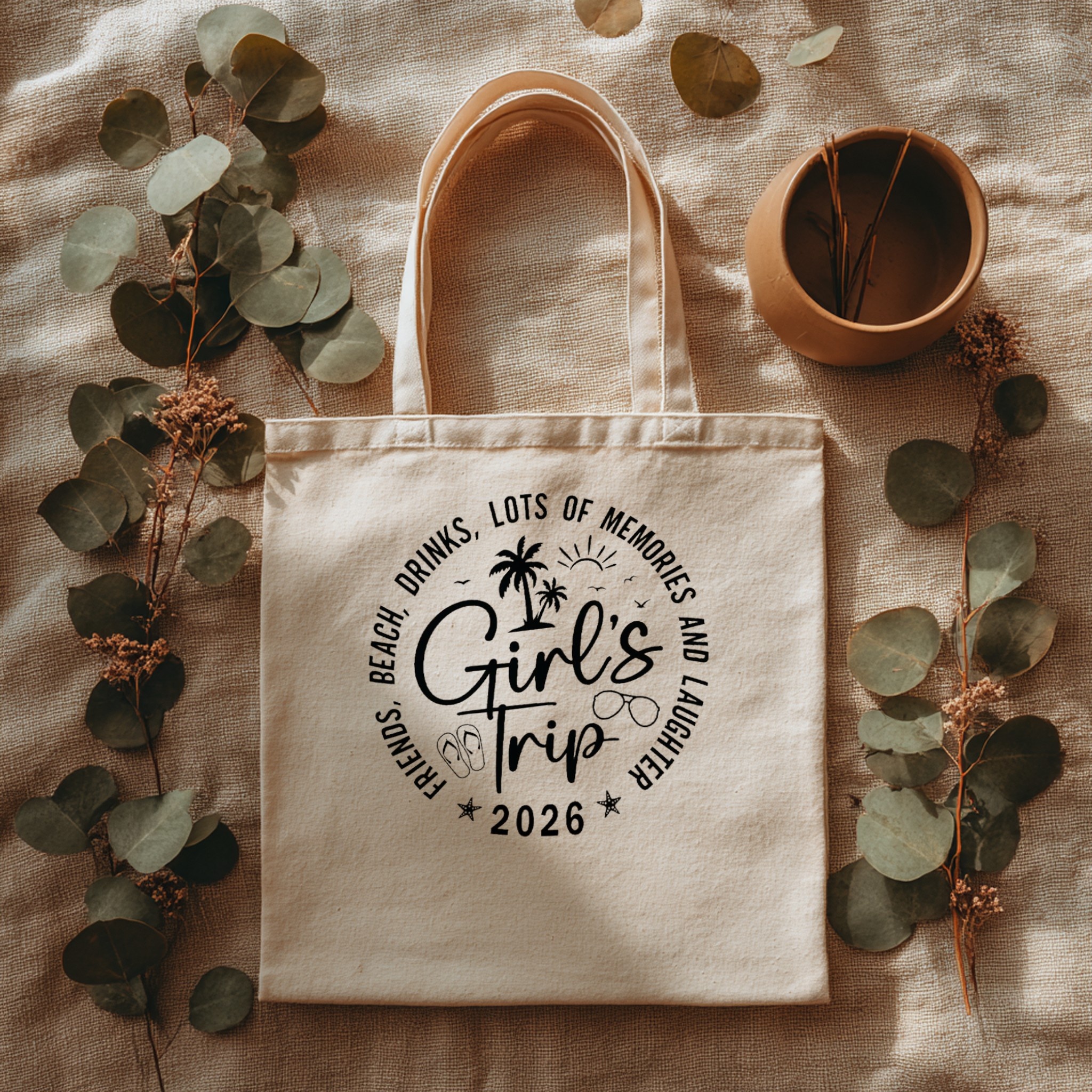 Tote bag with custom design surrounded by flower leaves — mockup example
